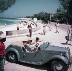 Slim Aarons, Katharine Hepburn, 1953: Driving along the waterfront with Irene Mayer Selznik at Montego Bay, Jamaica
